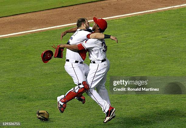 Mike Napoli and Neftali Feliz of the Texas Rangers celebrate winning Game Six of the American League Championship Series 15-5 against the Detroit...