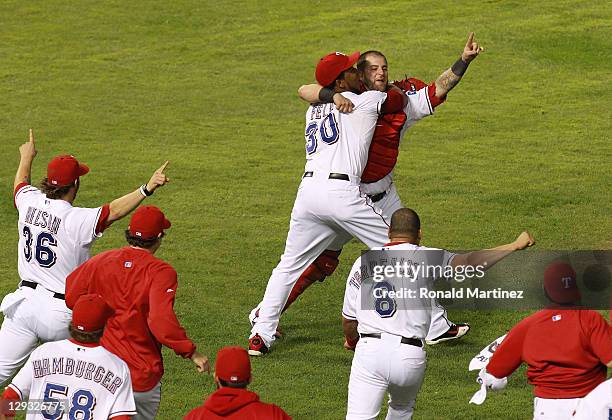 Mike Napoli and Neftali Feliz of the Texas Rangers celebrate winning Game Six of the American League Championship Series 15-5 against the Detroit...