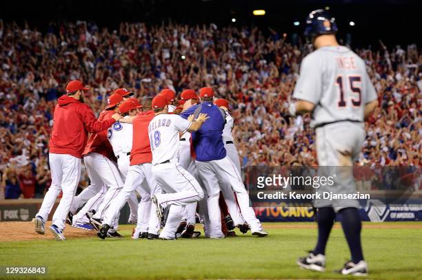 Brandon Inge of the Detroit Tigers walks off the field as the Texas Rangers celebrate winning Game Six of the American League Championship Series...