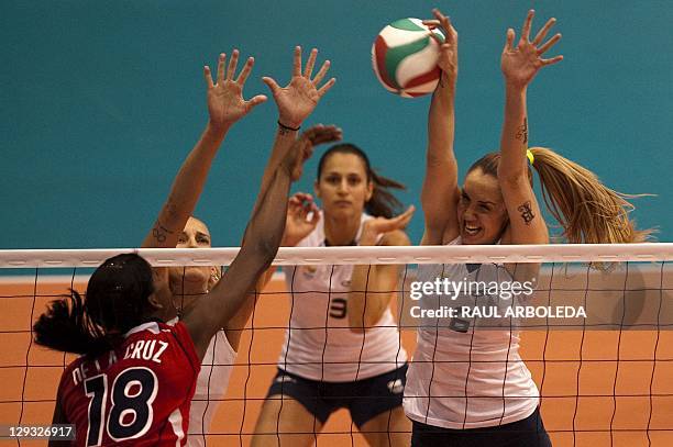 Thaisa Menenes of Brasil blocks the ball next to her teammate Danielle Lins in the Women's Volleyball Pool B Preliminary Round match againts...