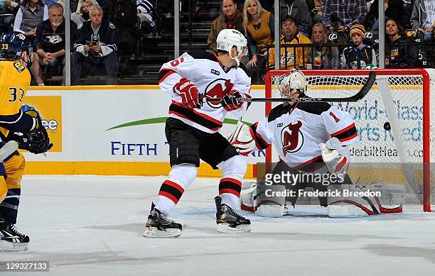 Johan Hedberg of the New Jersey Devils gives up a goal to Colin Wilson of the Nashville Predators at the Bridgestone Arena on October 15, 2011 in...
