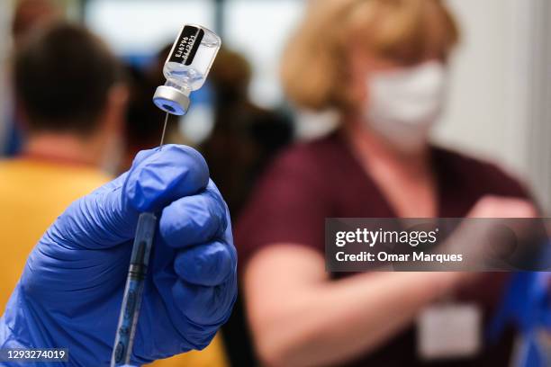 Nurse prepares a jab of Pfizer BioNTech Covid-19 vaccine during the first day of vaccination at Krakow University Hospital on December 27, 2020 in...