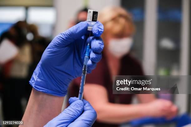 Nurse prepares a jab of Pfizer BioNTech Covid-19 vaccine during the first day of vaccination at Krakow University Hospital on December 27, 2020 in...