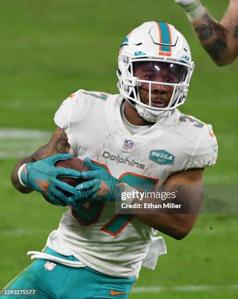 Running back Myles Gaskin of the Miami Dolphins scores a touchdown on a 59-yard pass play against the Las Vegas Raiders in the second half of their...