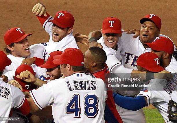 Ian Kinsler, Craig Gentry, Michael Young and Adrian Beltre of the Texas Rangers celebrate winning Game Six of the American League Championship Series...