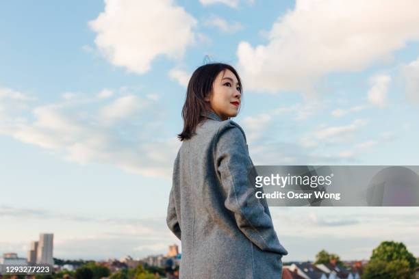 young woman planning for the future - young woman standing against clear sky stock pictures, royalty-free photos & images