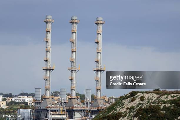 three chimneys of a liquefied natural gas (lng) power plant system - cng stock-fotos und bilder