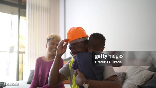 grandfather embracing grandson at home - returning home after work stock pictures, royalty-free photos & images