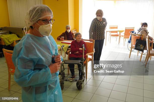 Doctor speaks to residents whom she had administered the Pfizer/BioNTech Covid-19 vaccine at a nursing home of the German Red Cross on the first day...