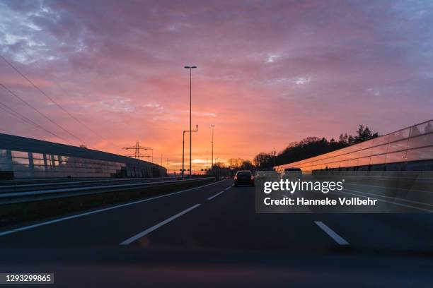 dramatic sunset while driving - twilight stock pictures, royalty-free photos & images