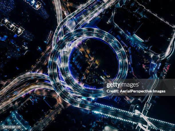 top view of overpass and road intersection at night - city network shanghai stock-fotos und bilder