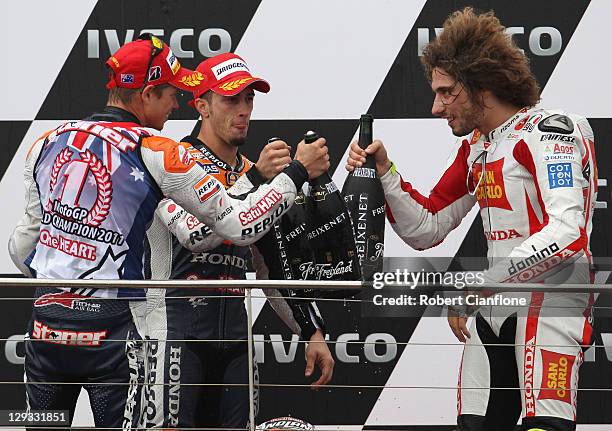 Casey Stoner of Australia and rider of the Repsol Honda Team Honda celebrates with Andrea Divizioso of Italy and Marco Simoncelli of Italy afterhe...