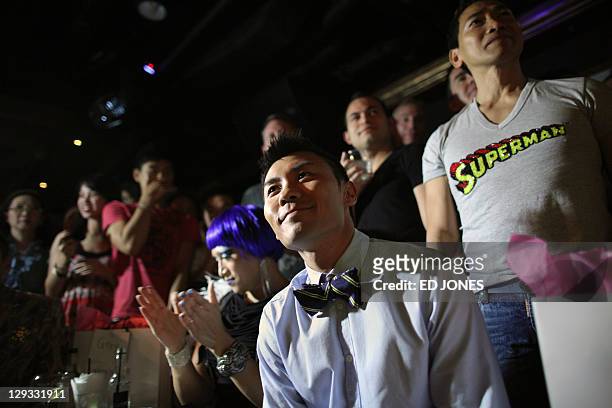 In a photo taken on October 15, 2011 'Mr. Gay Hong Kong 2011' judge Tony Wong watches the competition's final pageant at the Bisous nightclub in Hong...