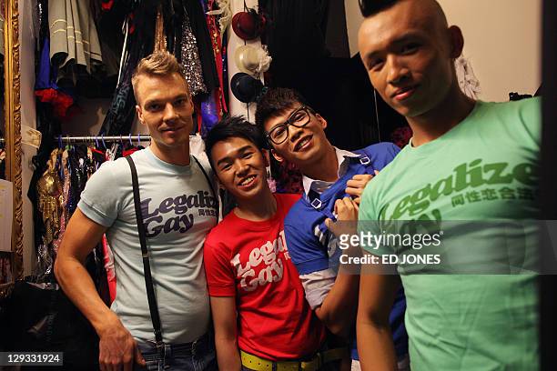 In a photo taken on October 15, 2011 'Mr. Gay Hong Kong 2011' contestants Jonathan Bridge Hudson, Ricky Chau Ka Wing, Edmund Lee Ho Chun, and winner...