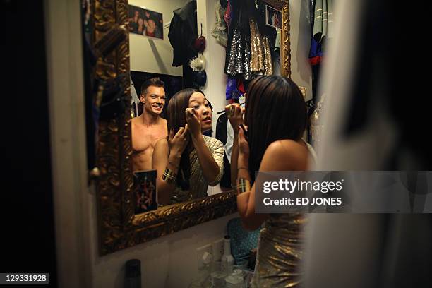 In a photo taken on October 15 host Valerie Soh and contestant Jonathan Bridge Hudson apply makeup before a 'Mr. Gay Hong Kong 2011' pageant at the...