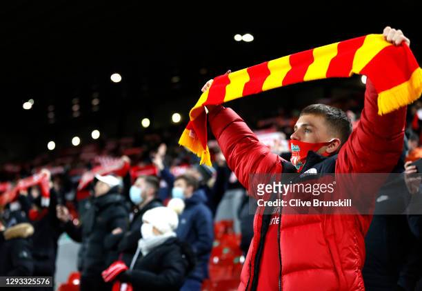 Liverpool fan sings in their socially-distanced seat during the Premier League match between Liverpool and West Bromwich Albion at Anfield on...