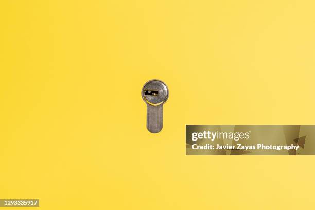 lock on yellow background - 鍵穴 ストックフォトと画像