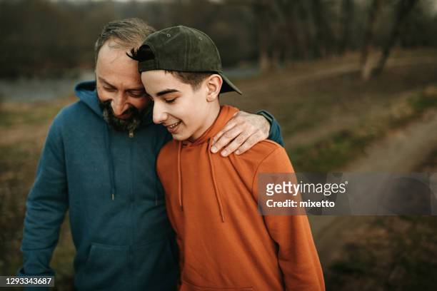 enjoying some father-son time - father stock pictures, royalty-free photos & images