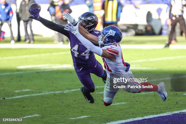 Cornerback Marlon Humphrey of the Baltimore Ravens breaks up a pass intended for wide receiver Austin Mack of the New York Giants during the second...