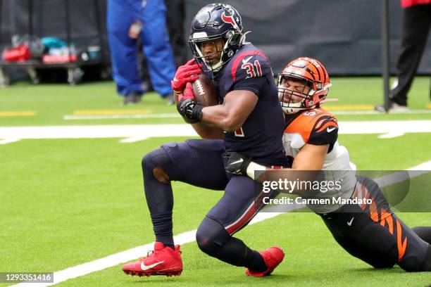Running back David Johnson of the Houston Texans completes a pass for a touchdown over linebacker Markus Bailey of the Cincinnati Bengals during the...