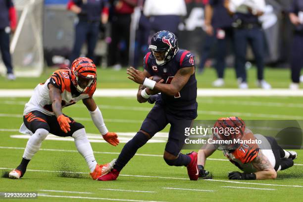 Quarterback Deshaun Watson of the Houston Texans scrambles against cornerback Darius Phillips and defensive end Margus Hunt of the Cincinnati Bengals...