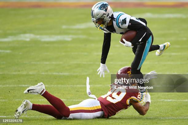 Robby Anderson of the Carolina Panthers attempts to break a tackle from Kendall Fuller of the Washington Football Team at FedExField on December 27,...