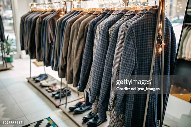 suits on rack - menswear stock pictures, royalty-free photos & images