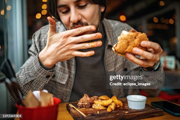 delicious burger - eat man stock pictures, royalty-free photos & images