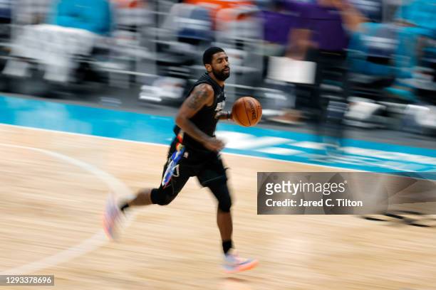 Kyrie Irving of the Brooklyn Nets dribbles during the second quarter of their game against the Charlotte Hornets at Spectrum Center on December 27,...