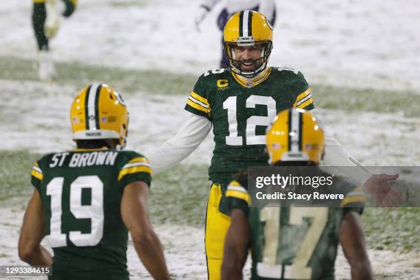 Quarterback Aaron Rodgers of the Green Bay Packers celebrates a touchdown pass to Equanimeous St. Brown against the Tennessee Titans during the...