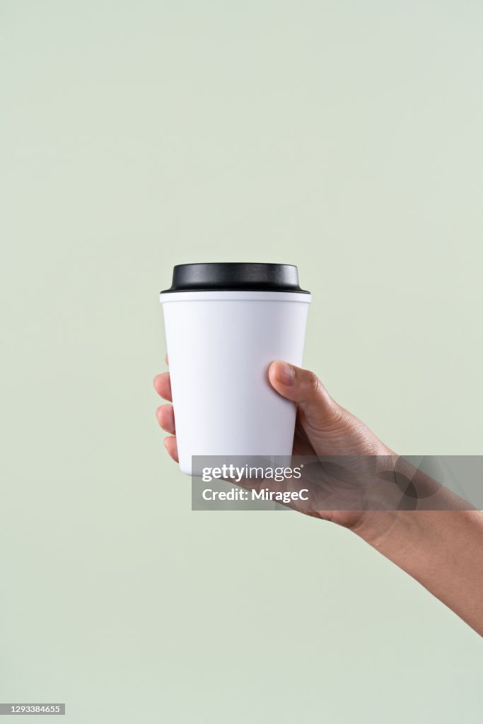 Hand Holding a Reusable Coffee Cup
