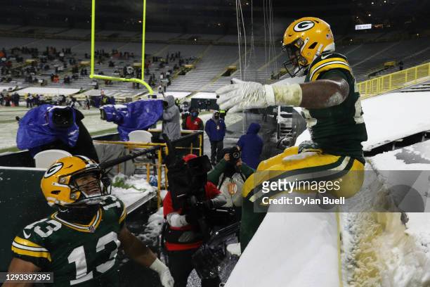 Dillon of the Green Bay Packers does the Lambeau Leap after scoring a touchdown against the Tennessee Titans during the fourth quarter at Lambeau...