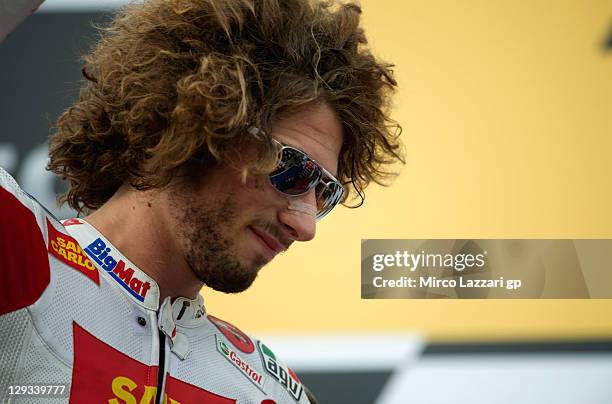 Marco Simoncelli of Italy and San Carlo Honda Gresini celebrates on the podium after the MotoGP race of the Australian MotoGP, which is round 16 of...