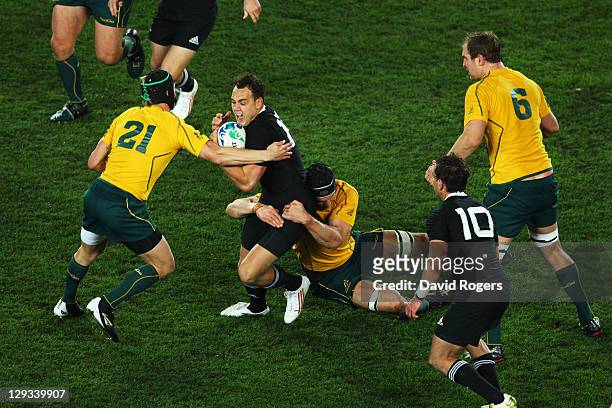 Israel Dagg of the All Blacks is tackled by Berrick Barnes and Dan Vickerman of the Wallabies during semi final two of the 2011 IRB Rugby World Cup...