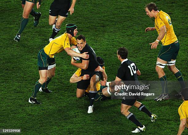 Israel Dagg of the All Blacks is tackled by Berrick Barnes and Dan Vickerman of the Wallabies during semi final two of the 2011 IRB Rugby World Cup...