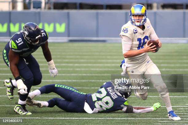 Jared Goff of the Los Angeles Rams runs with ball after breaking a tackle against Ugo Amadi of the Seattle Seahawks in the first quarter at Lumen...