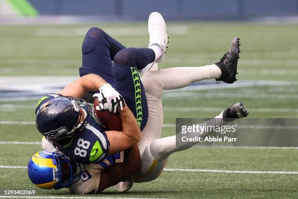 Greg Olsen of the Seattle Seahawks is tackled by John Johnson of the Los Angeles Rams in the second quarter at Lumen Field on December 27, 2020 in...