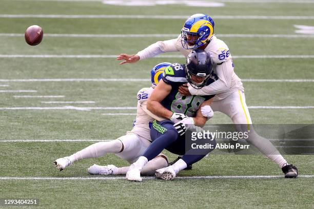 Jordan Fuller and Justin Hollins of the Los Angeles Rams break up a pass intended for Greg Olsen of the Seattle Seahawks in the second quarter at...