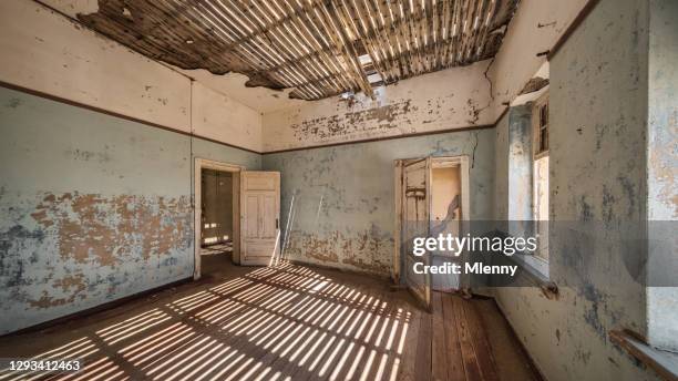 namibia ghost town light and shadow abandoned building kolmanskop panorama - kolmanskop namibia stock pictures, royalty-free photos & images