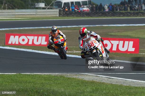 Marco Simoncelli of Italy and San Carlo Honda Gresini leads Andrea Dovizioso of Italy and Repsol Honda Team during the MotoGP race of the Australian...