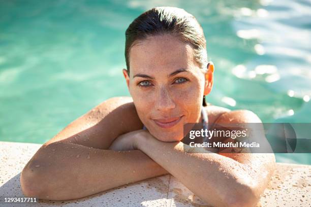 beautiful caucasian woman leaning on poolside - portrait pool stock pictures, royalty-free photos & images