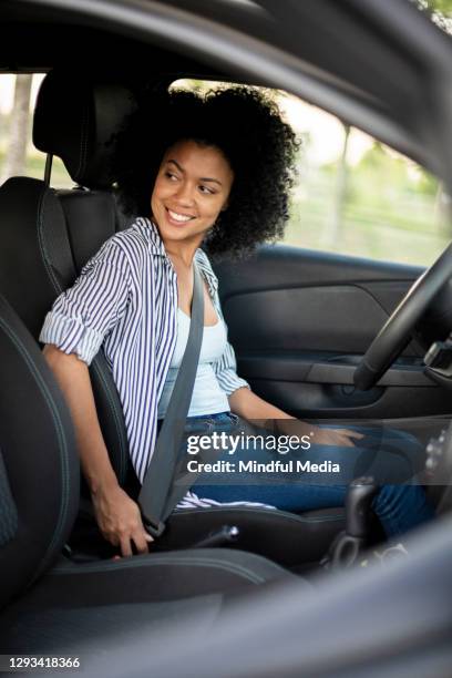 young woman sitting in car - car interior side stock pictures, royalty-free photos & images