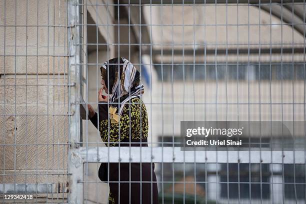 An Israeli Arab woman arrives to visit a relative, as Palestinian prisoners prepare to be transported out of Hasharon jail on October 16, 2011 in Tel...