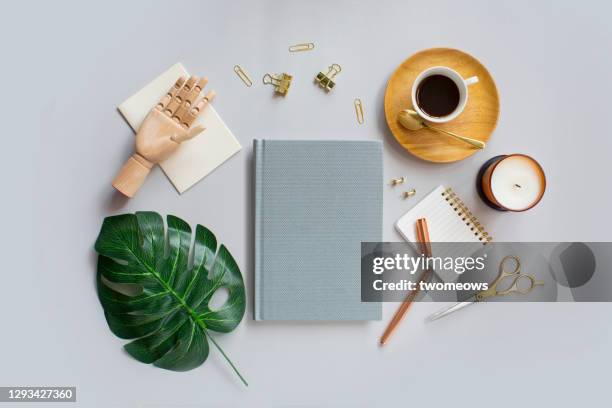 flat lay stylised objects and empty book cover on grey coffee table top still life. - candle overhead stock pictures, royalty-free photos & images