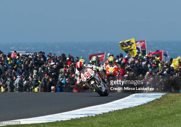 Marco Simoncelli of Italy and San Carlo Honda Gresini leads Valentino Rossi of Italy and Ducati Marlboro Team during the MotoGP race of the...
