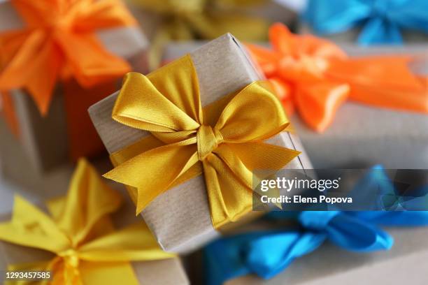 gift boxes with multi colored bows - boxing day stock pictures, royalty-free photos & images