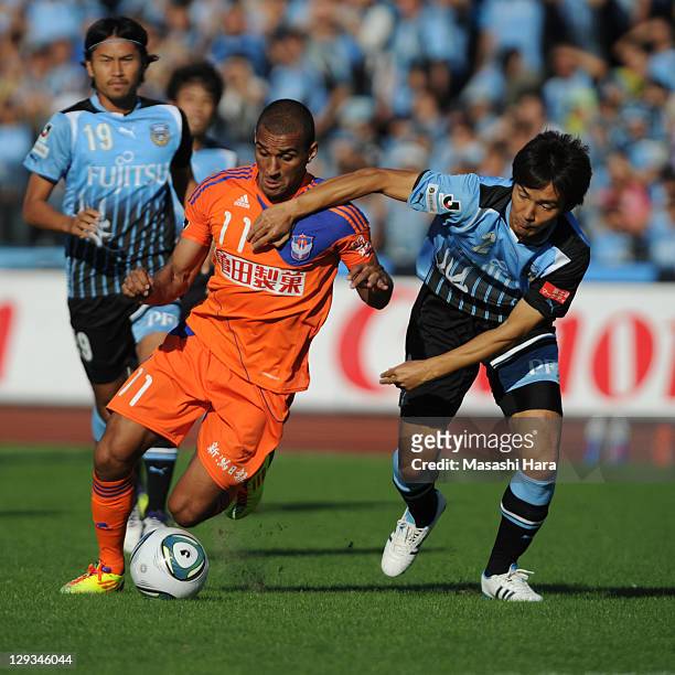 Bruno Lopes of Albirex Niigata and Hiroki Ito of Kawasaki Frontale compete for the ball during the J.League match between Kawasaki Frontale and...