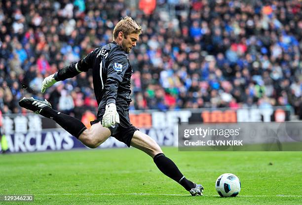 West Ham United's English goalkeeper Robert Green kicks the ball during the English Premier League football match against Wigan Athletic at The DW...