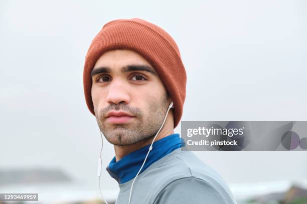 20-24 years old men running at coastline on cold temperature - 20 24 years photos stock pictures, royalty-free photos & images