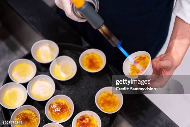 torching creme brulee - creme brulee stock pictures, royalty-free photos & images